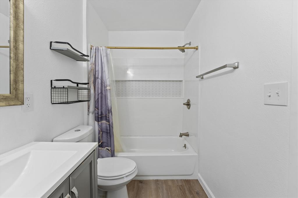 9521 Dalrock Road Rowlett, TX 75089 - Photo 23 of 38 a bathroom with a bathtub shower sink vanity and toilet