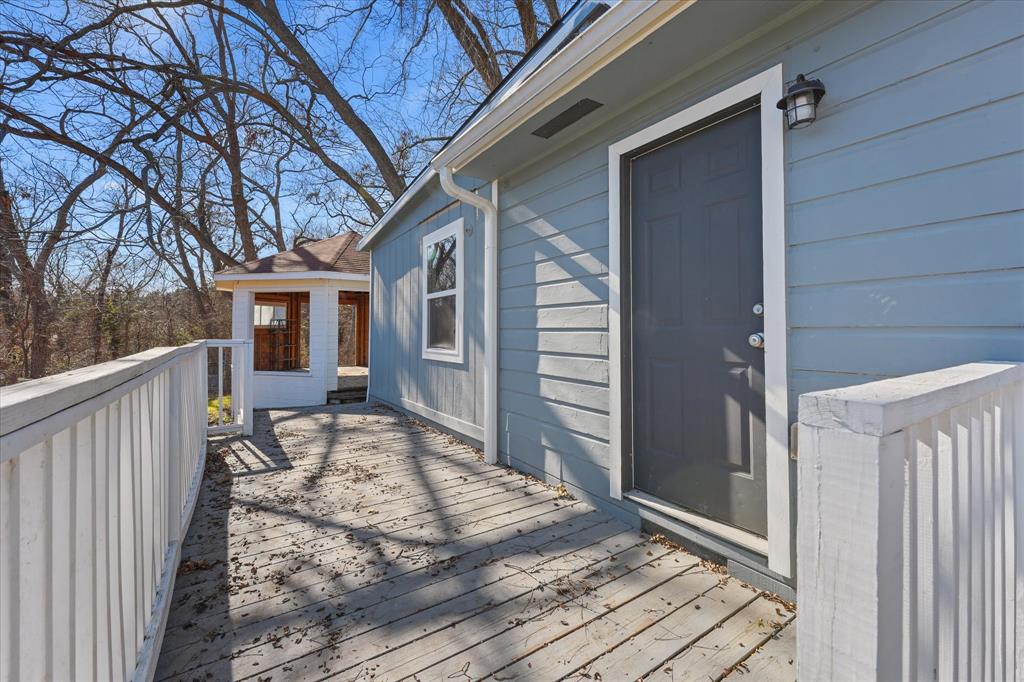 9521 Dalrock Road Rowlett, TX 75089 - Photo 29 of 38 a house view with a wooden deck and a outdoor space