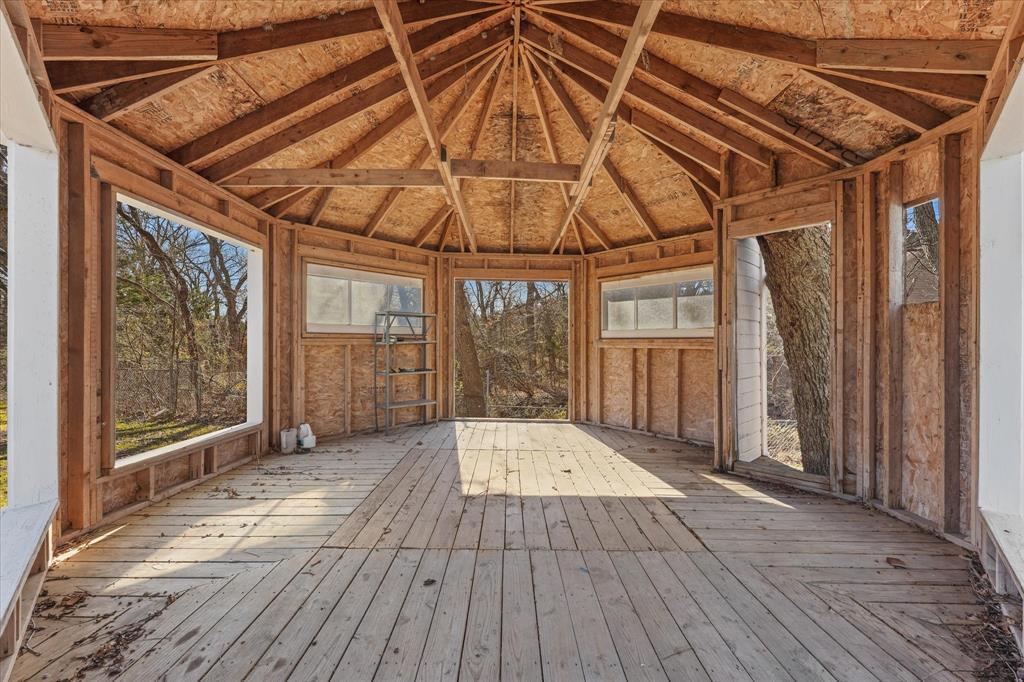 9521 Dalrock Road Rowlett, TX 75089 - Photo 30 of 38 a view of an empty room with wooden floor and doors