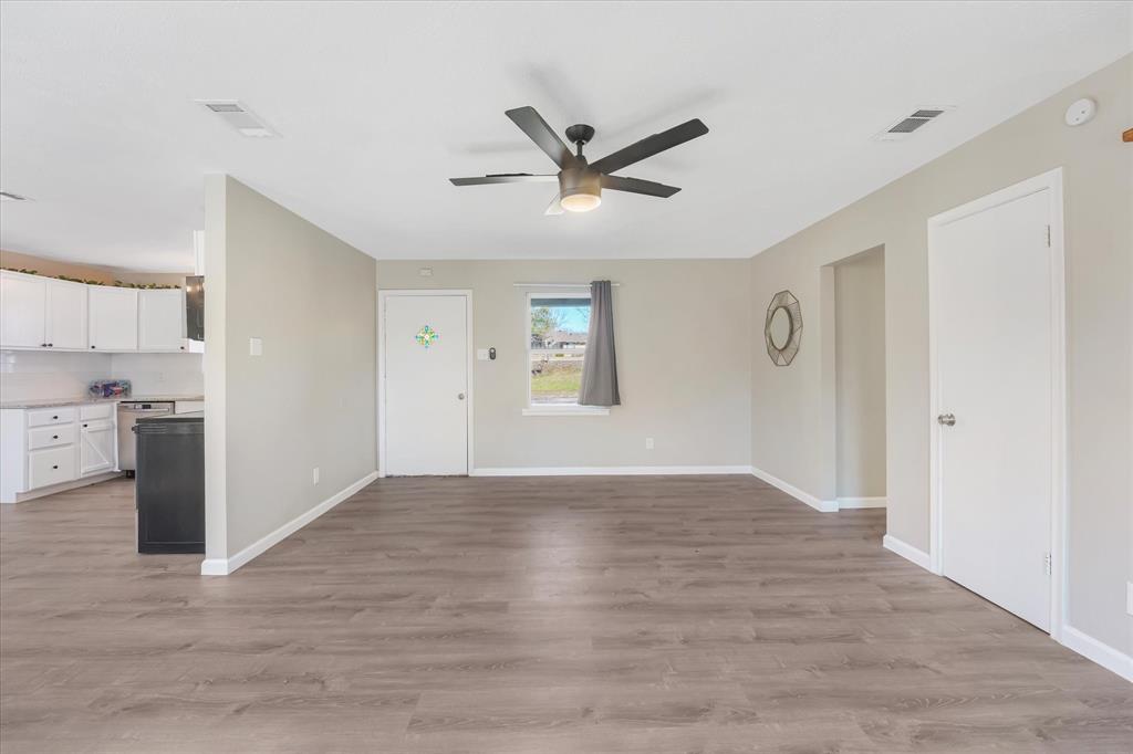 9521 Dalrock Road Rowlett, TX 75089 - Photo 4 of 38 a view of empty room with wooden floor and window