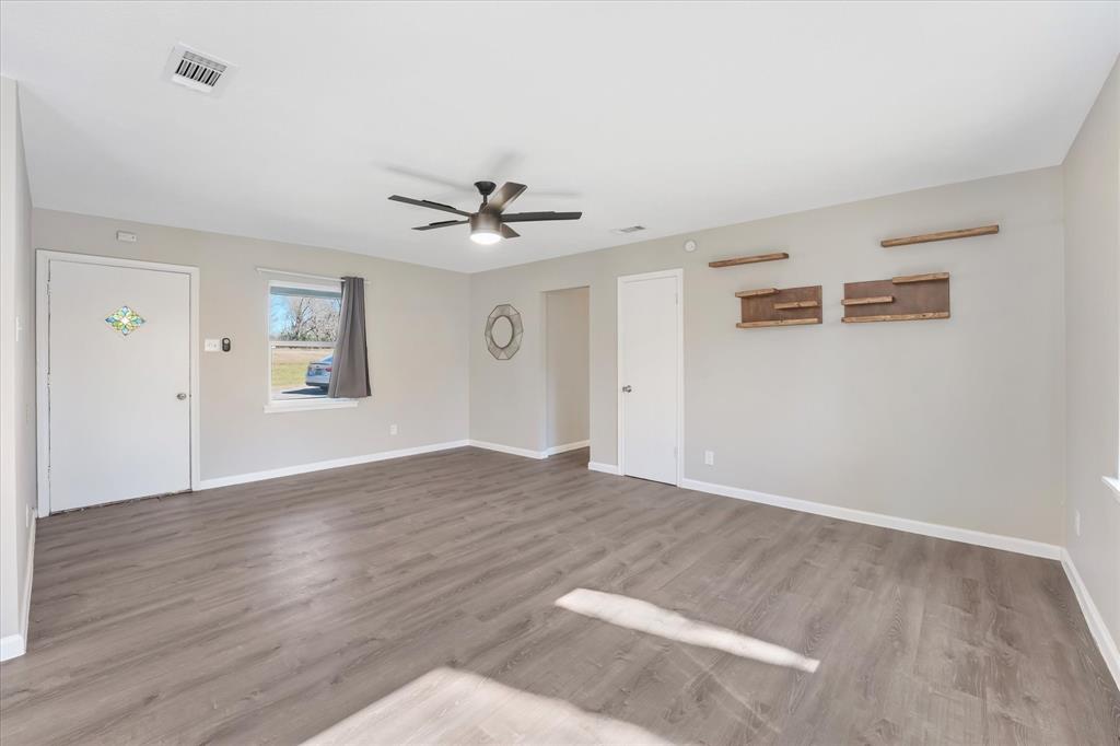 9521 Dalrock Road Rowlett, TX 75089 - Photo 5 of 38 a view of an empty room with window and wooden floor