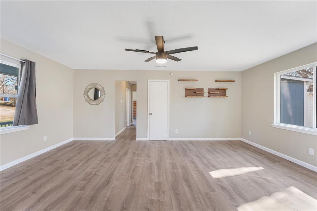 9521 Dalrock Road Rowlett, TX 75089 - Photo 6 of 38 a view of empty room with wooden floor and ceiling fan