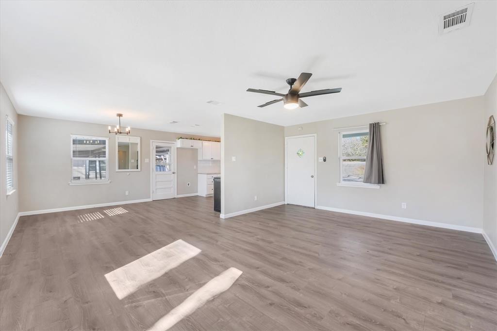 9521 Dalrock Road Rowlett, TX 75089 - Photo 7 of 38 an empty room with windows and ceiling fan