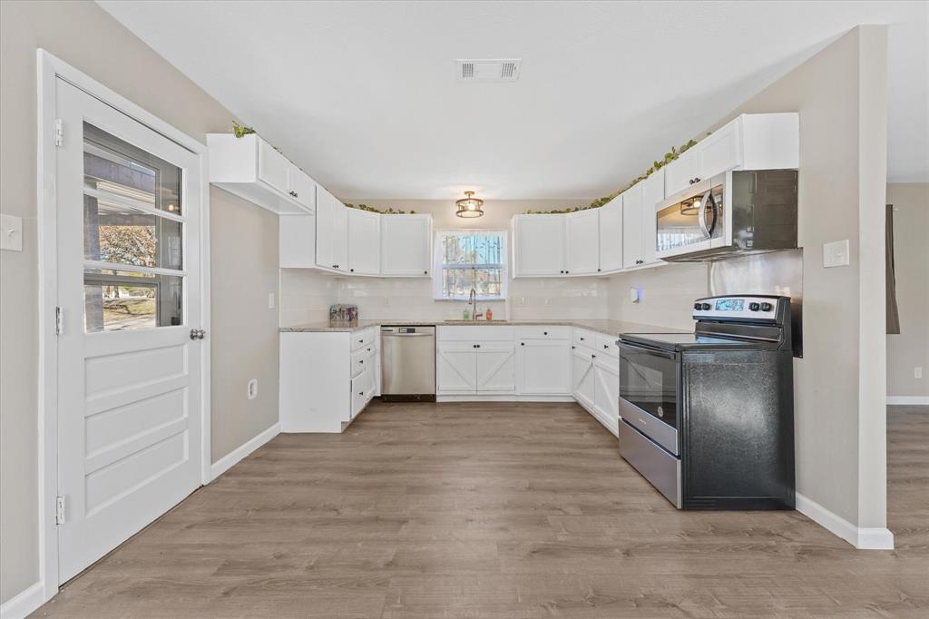 9521 Dalrock Road Rowlett, TX 75089 - Photo 9 of 38 a kitchen with stainless steel appliances granite countertop a refrigerator sink and cabinets