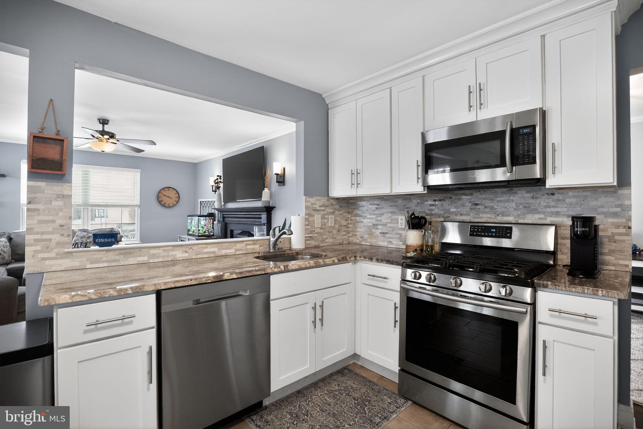 9 Bromley Court Atco, NJ 08004 - Photo 15 of 36 a kitchen with stainless steel appliances granite countertop grey cabinets a stove a sink and a microwave