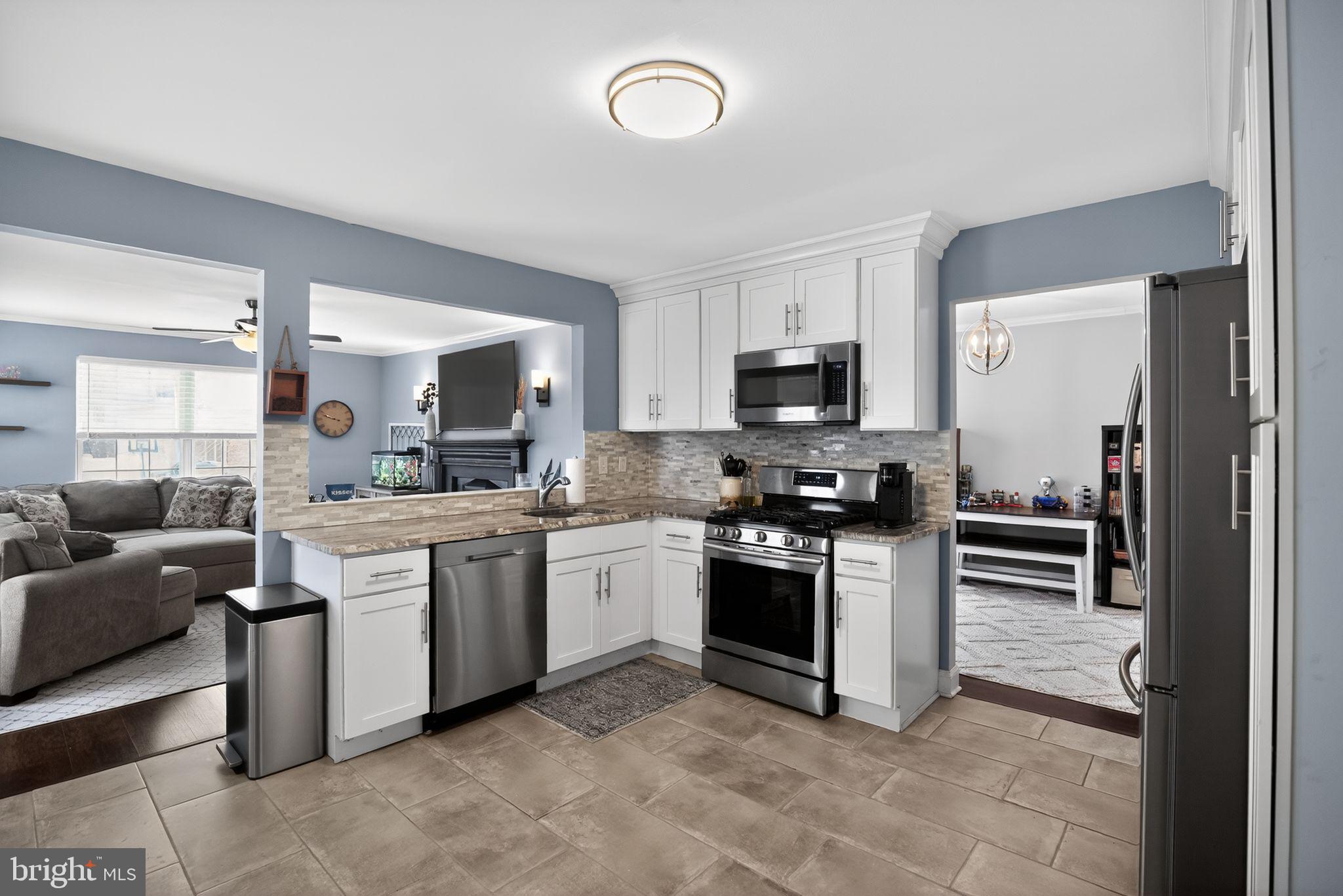 9 Bromley Court Atco, NJ 08004 - Photo 17 of 36 a kitchen with stainless steel appliances granite countertop a stove top oven a sink dishwasher a dining table and chairs