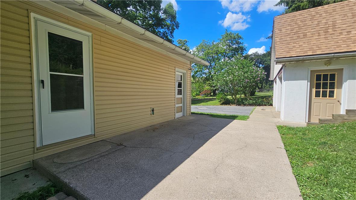 2529 Ringhoffer Road Hellertown, PA 18055 - Photo 21 of 33 Concrete pathways lead to the building's entries, flanked by a well-kept yard and verdant trees.