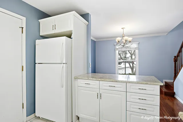 a kitchen with cabinets and a refrigerator