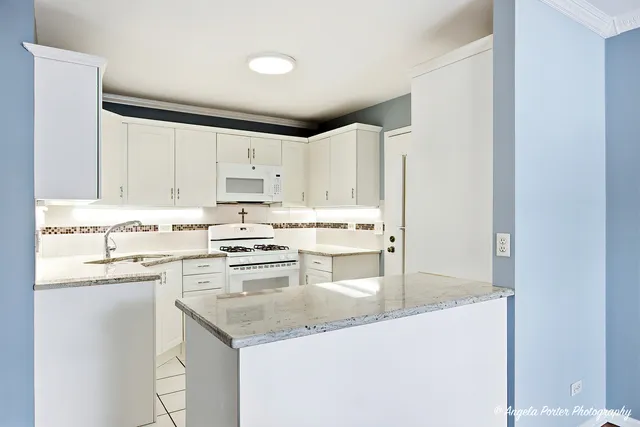 a kitchen with stainless steel appliances granite countertop a sink and cabinets