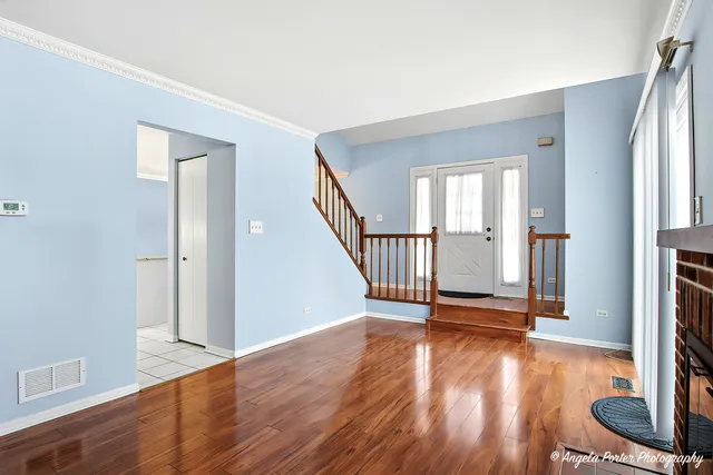 a view of an entryway with wooden floor and door