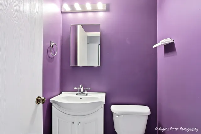 a bathroom with a sink mirror and toilet
