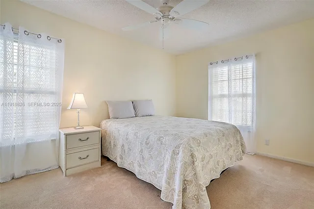 a view of walk in closet with clothes