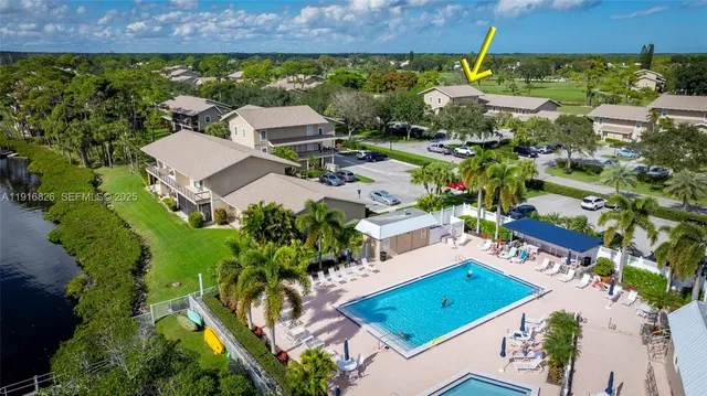 an aerial view of a residential houses with outdoor space and seating