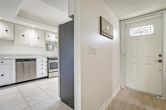 a view of a kitchen with cabinets and wooden floor