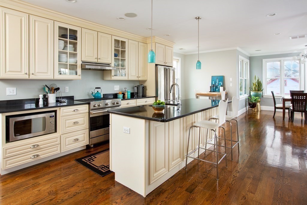 14 Castleton Street, Unit 2 Boston, MA 02130 - Photo 1 of 23 a kitchen with stainless steel appliances kitchen island granite countertop a stove a sink and white cabinets
