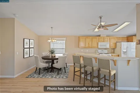a dining room with wooden floor and a window