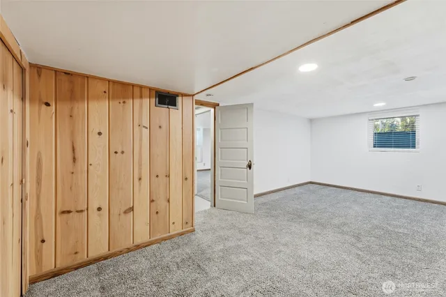 a view of an empty room with a closet and a cabinet