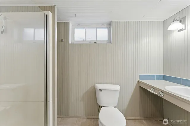 a bathroom with a glass shower door
