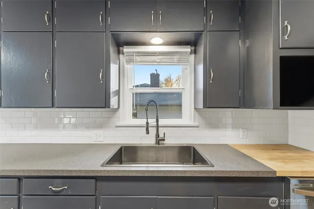 a kitchen with a sink and a refrigerator