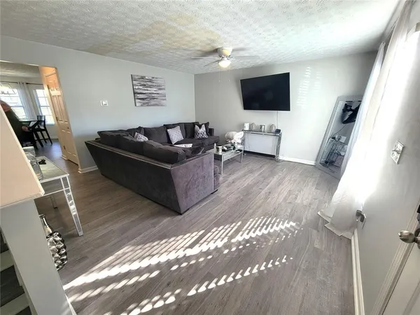 a living room with furniture and a flat screen tv