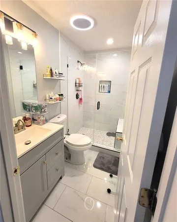 a bathroom with a sink a toilet and a mirror