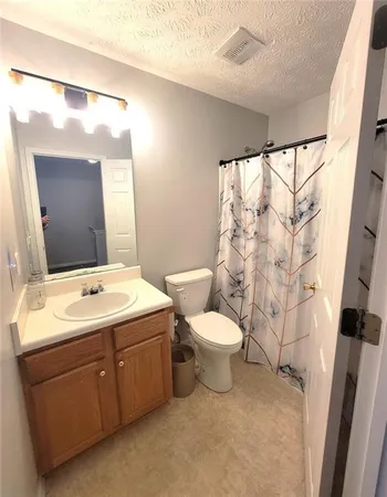 a bathroom with a sink toilet and mirror