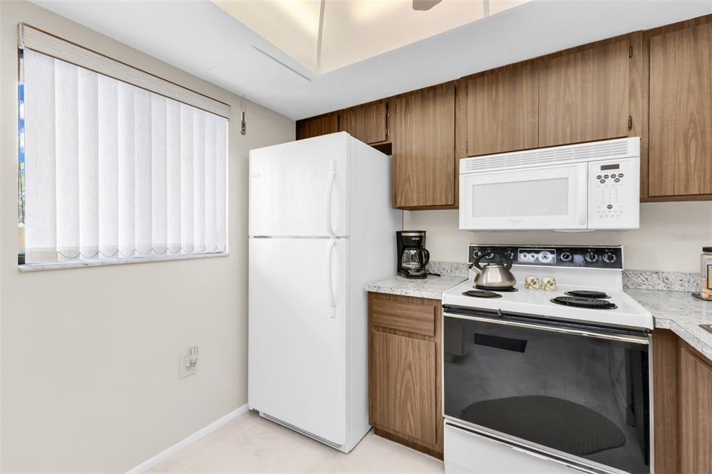 25225 Rampart Boulevard, Unit 1604 Punta Gorda, FL 33983 - Photo 14 of 41 a kitchen with a refrigerator sink and cabinets