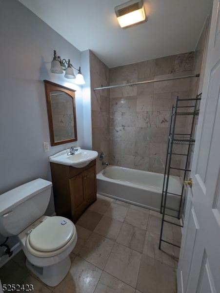 19 Market Street, Unit 405 Paterson, NJ 07501 - Photo 13 of 19 a bathroom with a toilet sink and mirror