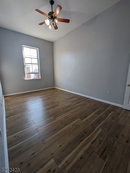 19 Market Street, Unit 405 Paterson, NJ 07501 - Photo 14 of 19 wooden floor in an empty room with a window