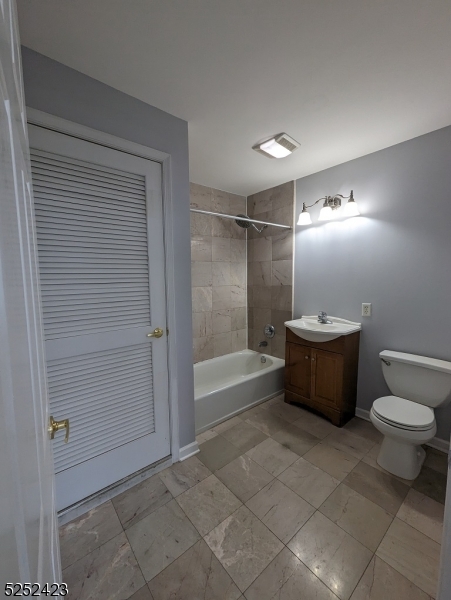 19 Market Street, Unit 405 Paterson, NJ 07501 - Photo 17 of 19 a bathroom with a toilet a sink and shower