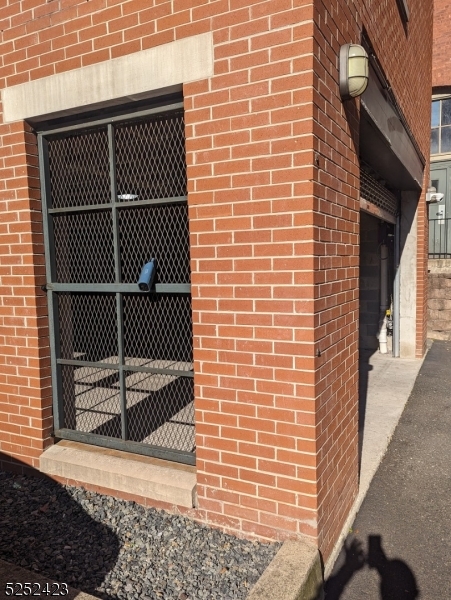 19 Market Street, Unit 405 Paterson, NJ 07501 - Photo 19 of 19 a view of a brick building and wooden floor