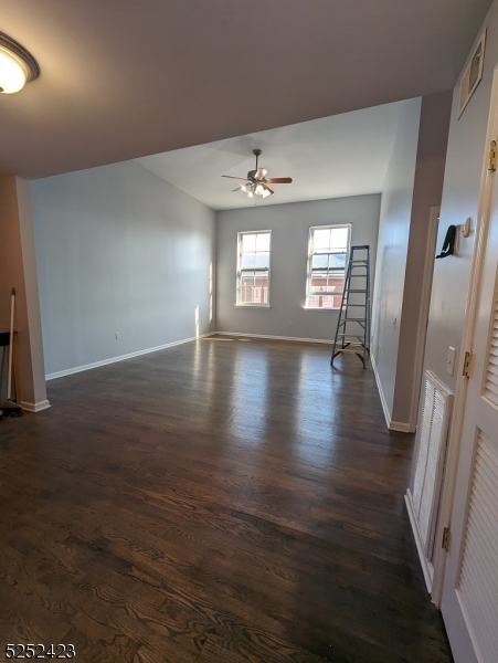 19 Market Street, Unit 405 Paterson, NJ 07501 - Photo 7 of 19 an empty room with wooden floor and windows