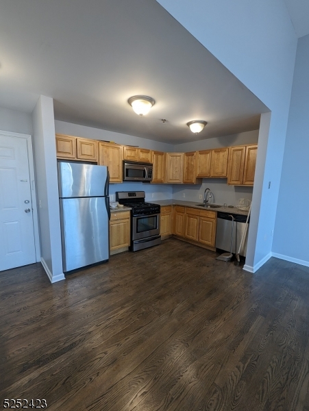 19 Market Street, Unit 405 Paterson, NJ 07501 - Photo 8 of 19 a view of a kitchen with a sink wooden floor and a window