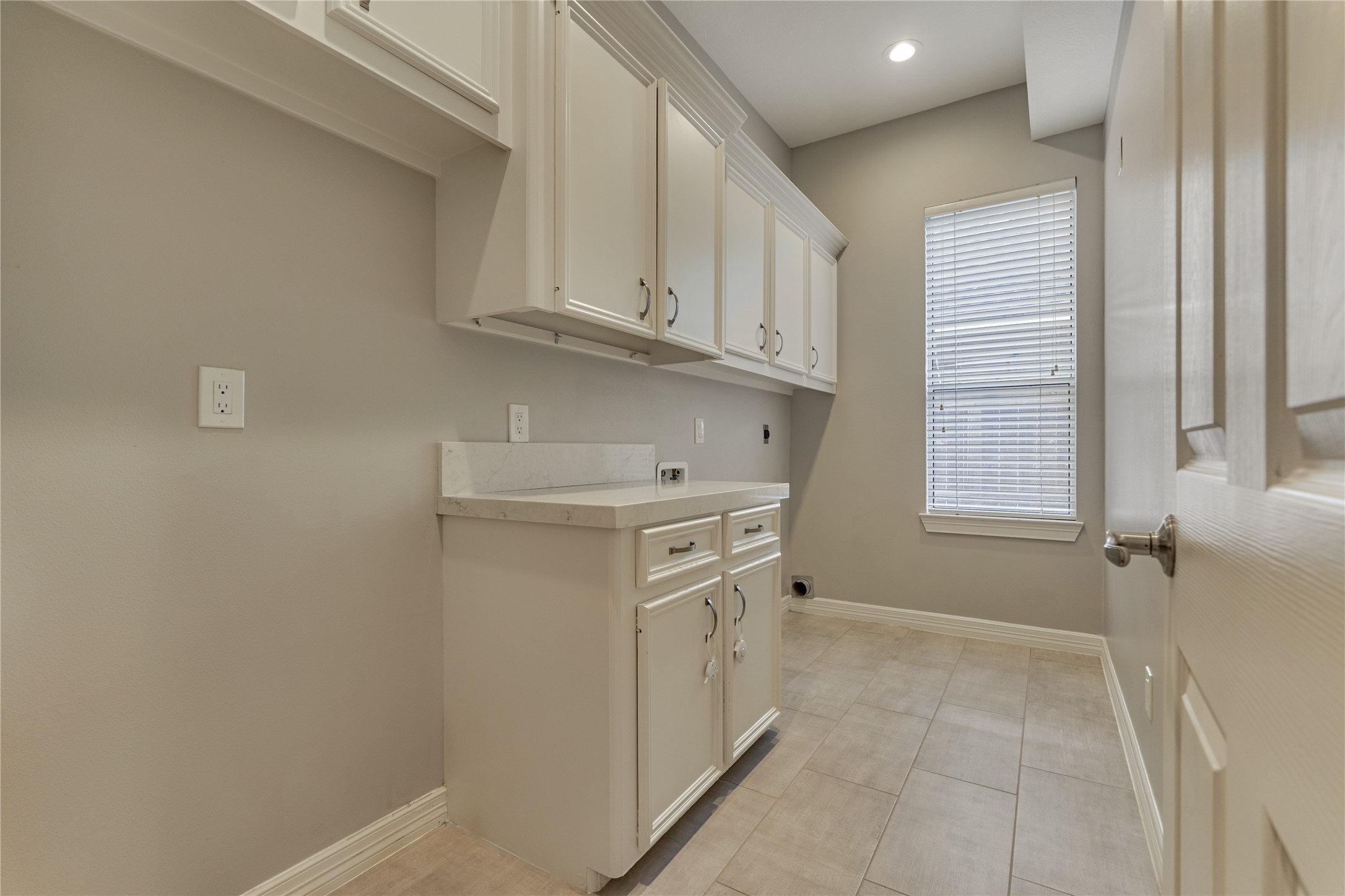 7 Gentry Oak Court Spring, TX 77381 - Photo 22 of 50 a view of a kitchen with white cabinets