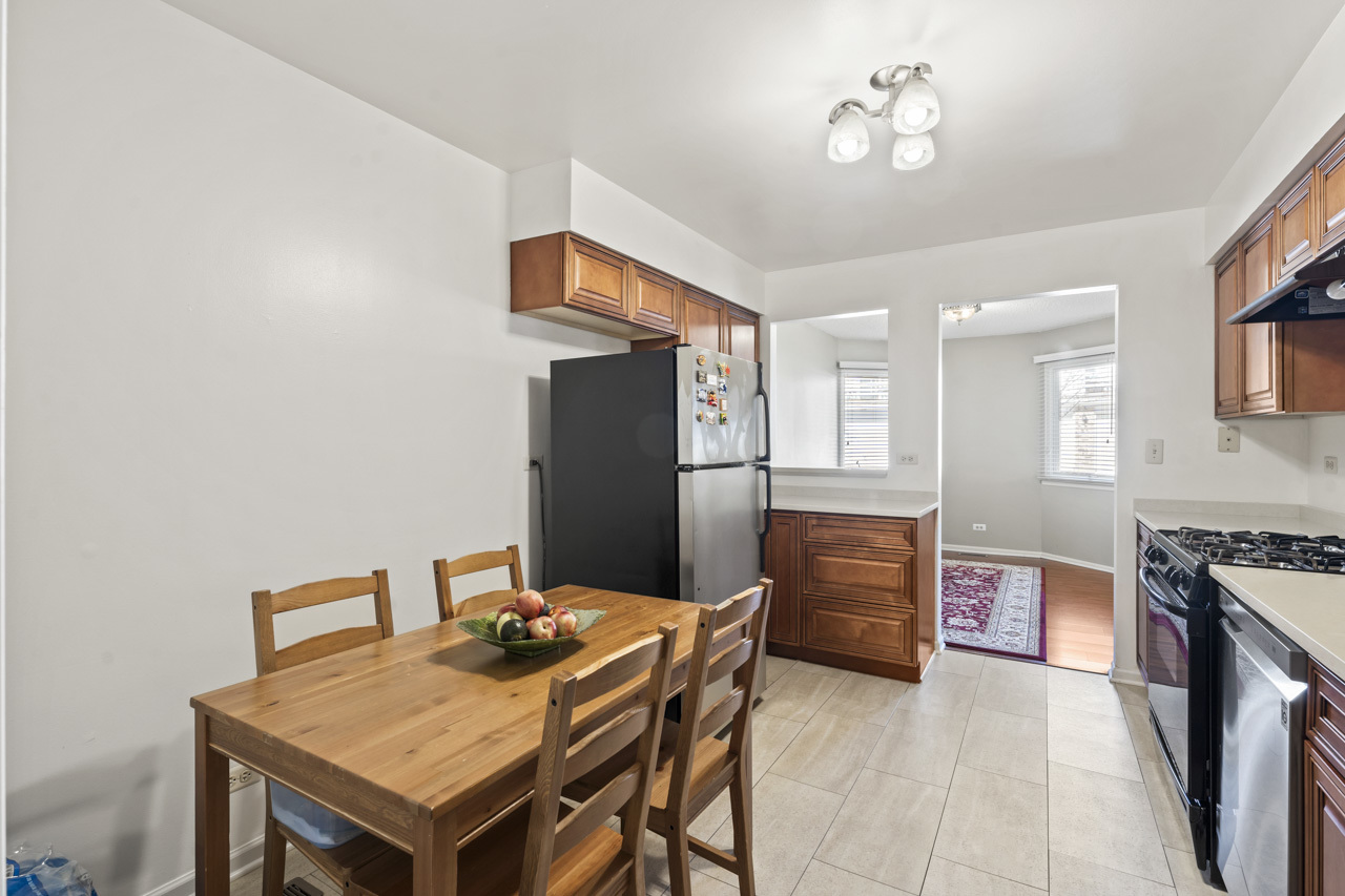1265 Ranchview Court Buffalo Grove, IL 60089 - Photo 11 of 24 a kitchen with stainless steel appliances granite countertop a stove refrigerator and a stove