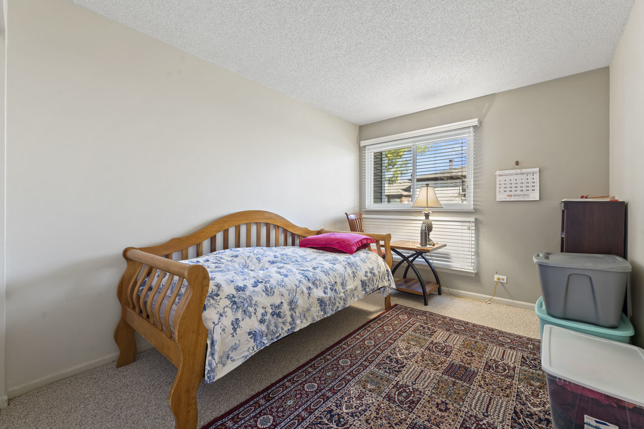 1265 Ranchview Court Buffalo Grove, IL 60089 - Photo 12 of 24 a bedroom with a bed and a flat screen tv