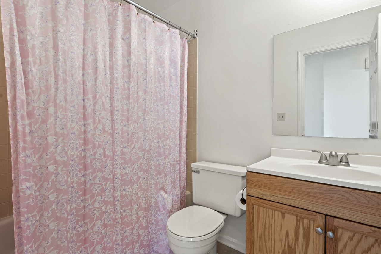 1265 Ranchview Court Buffalo Grove, IL 60089 - Photo 13 of 24 a bathroom with a sink a toilet and a mirror
