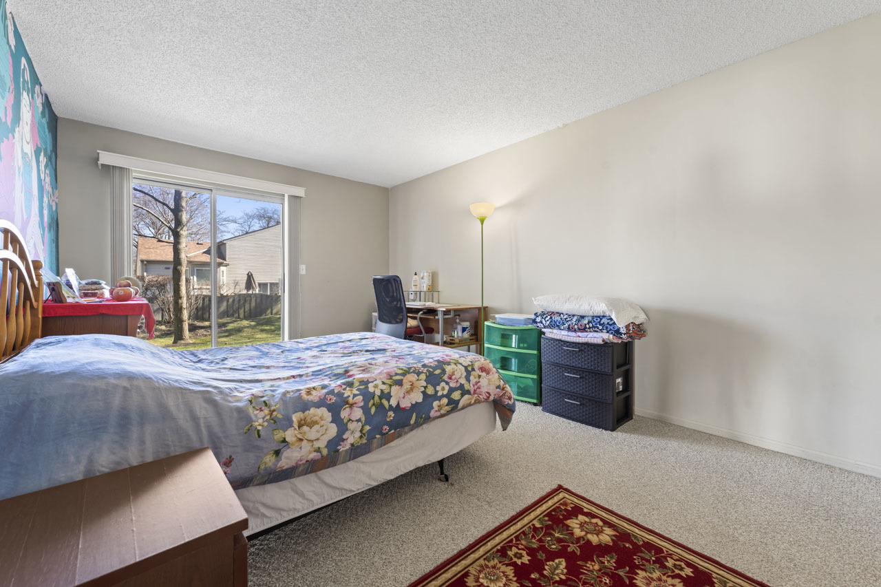 1265 Ranchview Court Buffalo Grove, IL 60089 - Photo 14 of 24 a bedroom with a bed and a large window