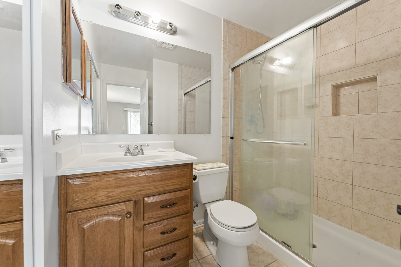 1265 Ranchview Court Buffalo Grove, IL 60089 - Photo 15 of 24 a bathroom with a sink a toilet and shower