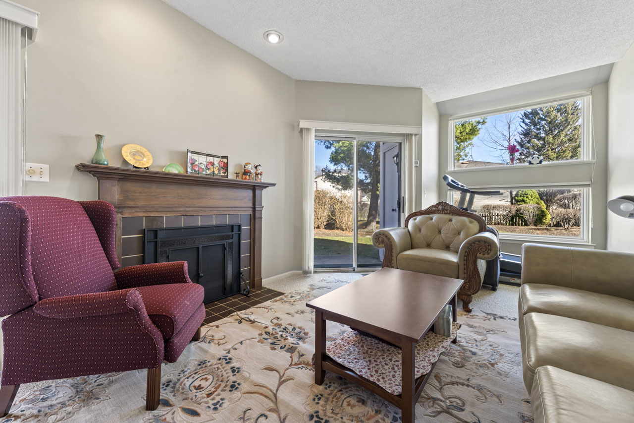 1265 Ranchview Court Buffalo Grove, IL 60089 - Photo 6 of 24 a living room with furniture a flat screen tv and a fireplace