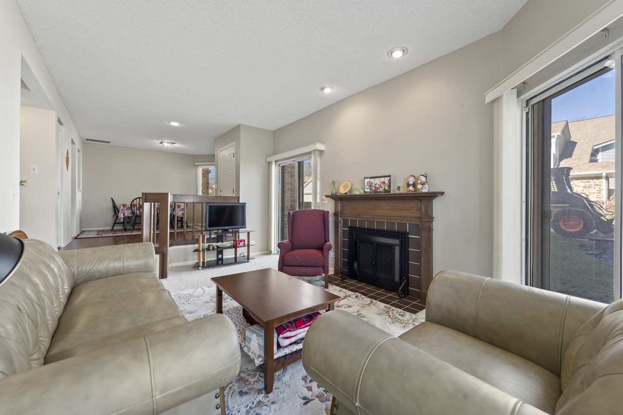 1265 Ranchview Court Buffalo Grove, IL 60089 - Photo 7 of 24 a living room with furniture and a fireplace