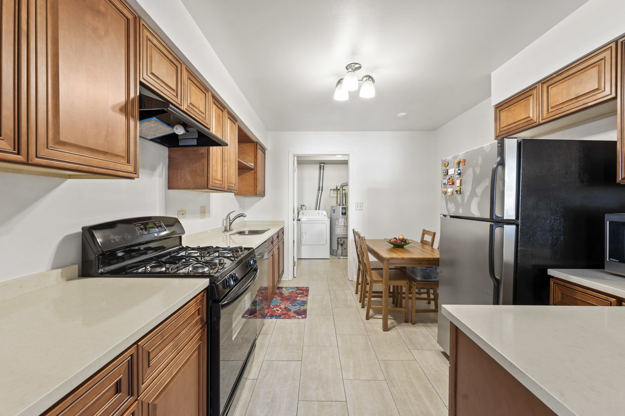 1265 Ranchview Court Buffalo Grove, IL 60089 - Photo 8 of 24 a kitchen with stainless steel appliances granite countertop a sink stove and refrigerator