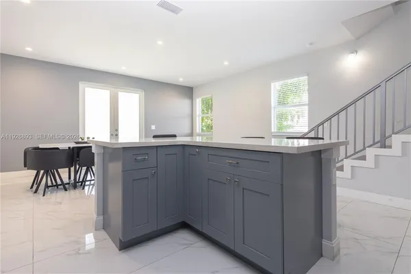 a kitchen with stainless steel appliances a sink stove and cabinets