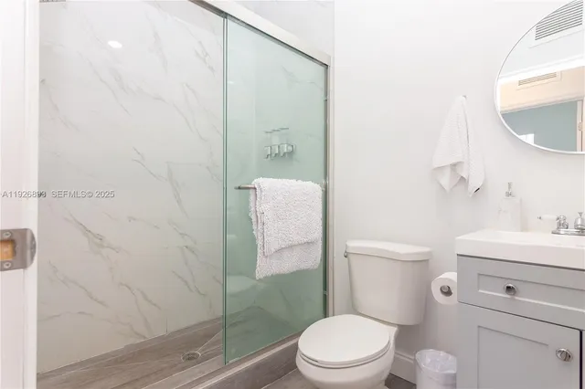 a bathroom with a toilet a sink and a mirror