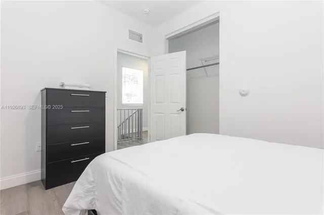 a bedroom with a bed and a dresser