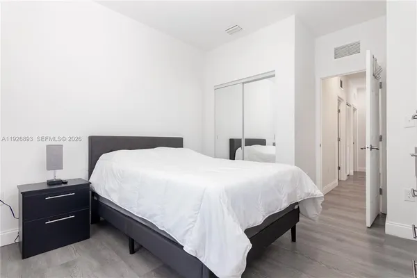 a bedroom with a bed and a view of bathroom