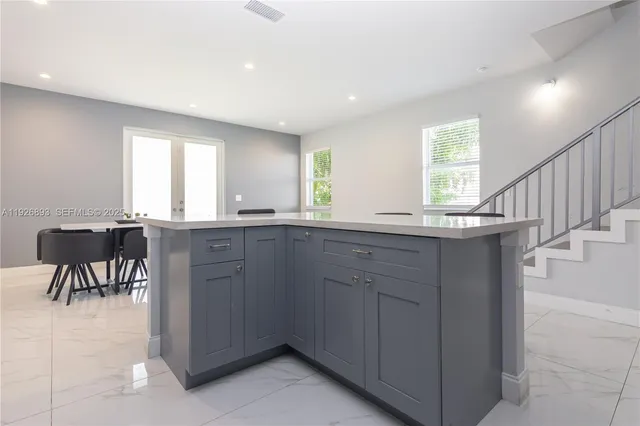 a kitchen with granite countertop sink cabinets and window