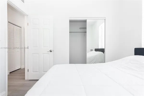 a view of bedroom with wooden floor