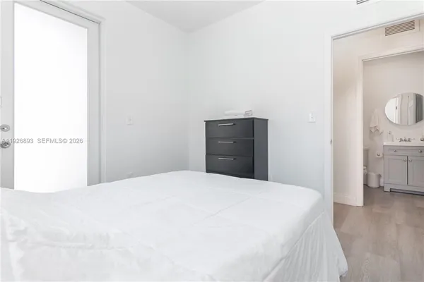 a bedroom with a bed and a mirror