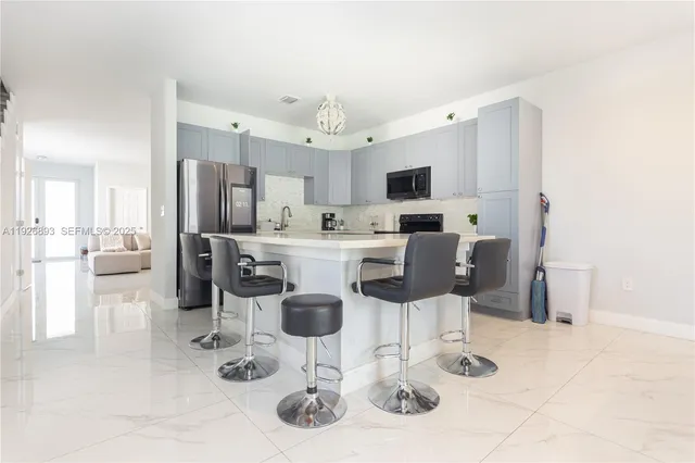 a kitchen with stainless steel appliances kitchen island granite countertop a sink and cabinets